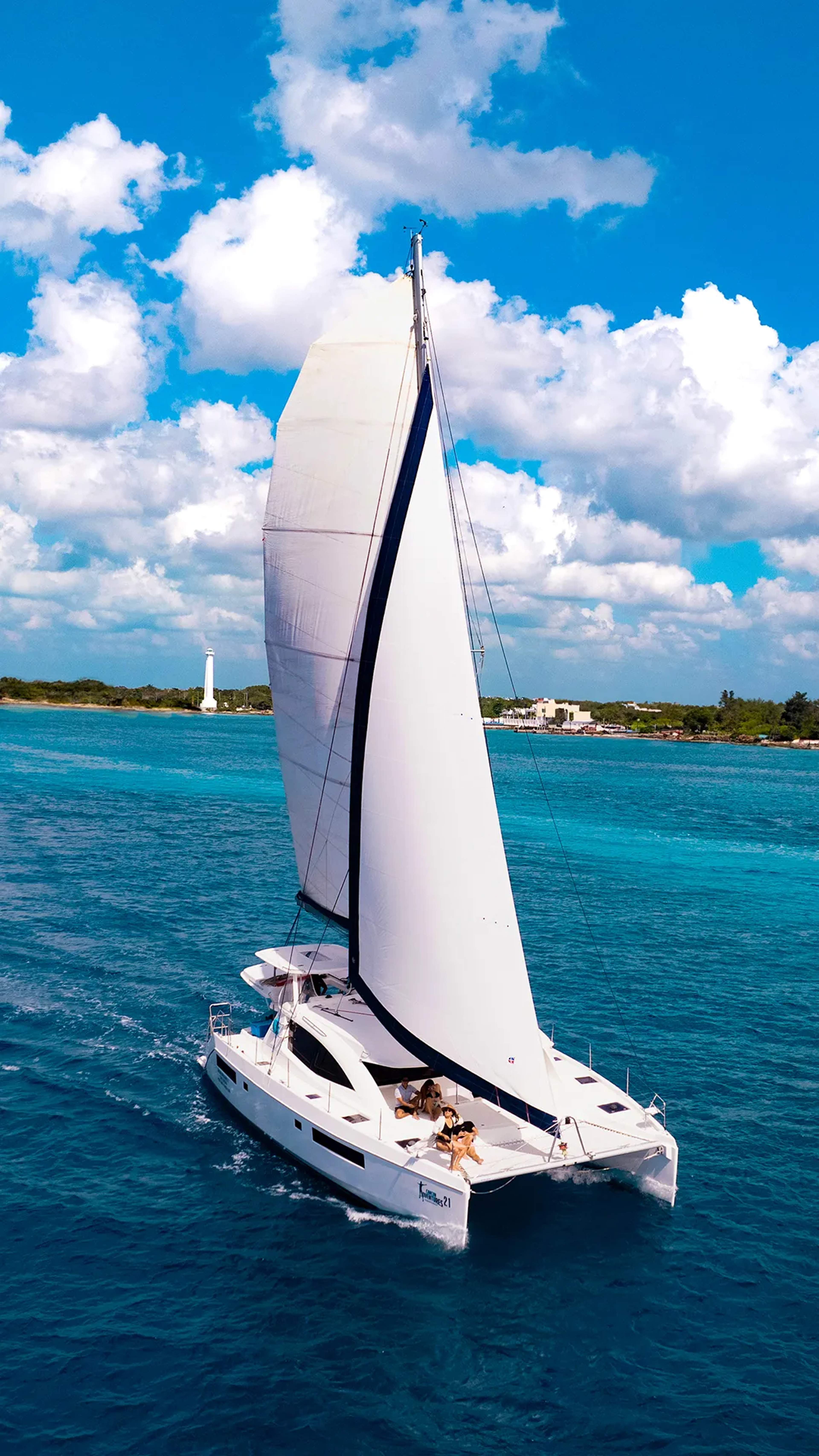 Cozumel catamaran sailing through turquoise Caribbean waters on a scenic luxury snorkeling tour.