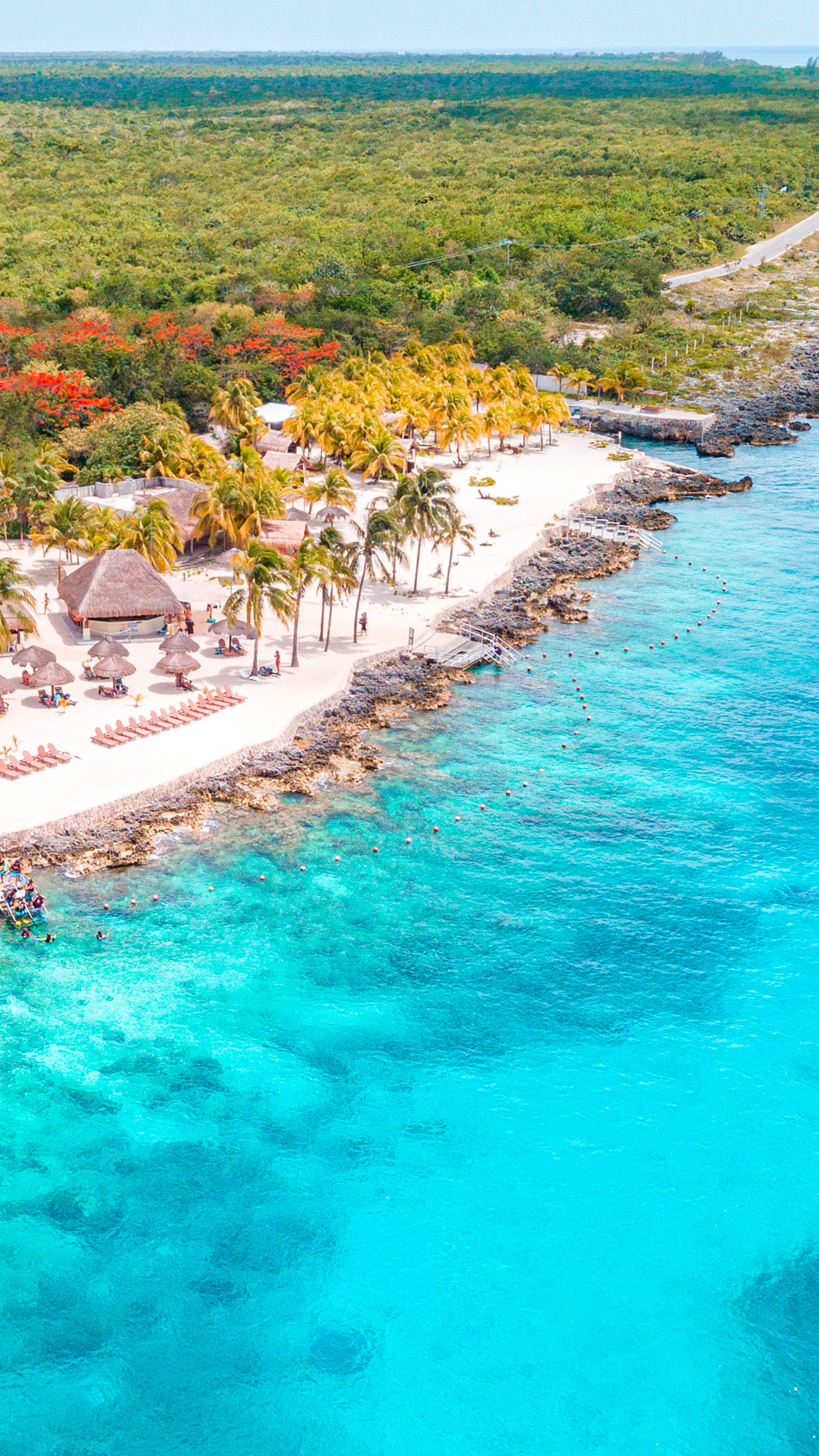 Vista aérea de club de playa en Cozumel y aguas turquesa durante tour de snorkel de lujo