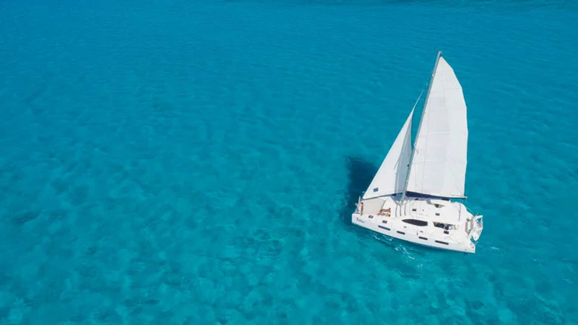 Sailing on the crystal-clear waters of Isla Mujeres, a perfect way to explore the island's beauty and enjoy the serene Caribbean Sea.