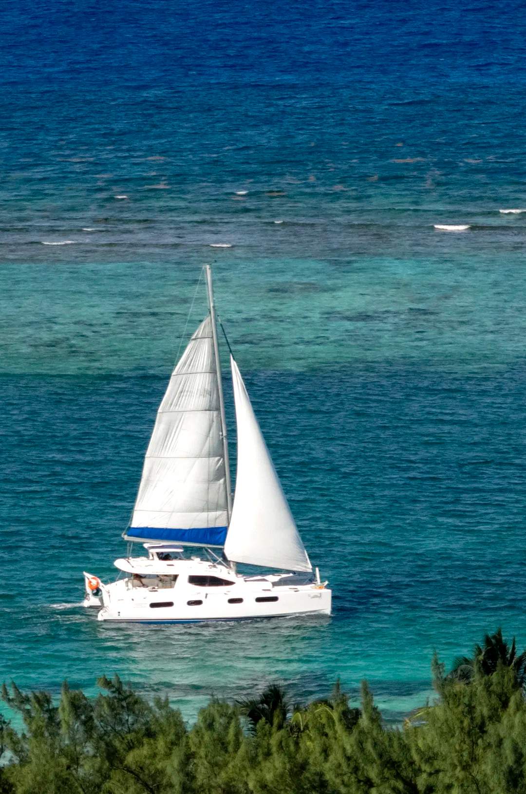 Puerto Morelos catamaran cruising the turquoise waters of the Mexican Caribbean.