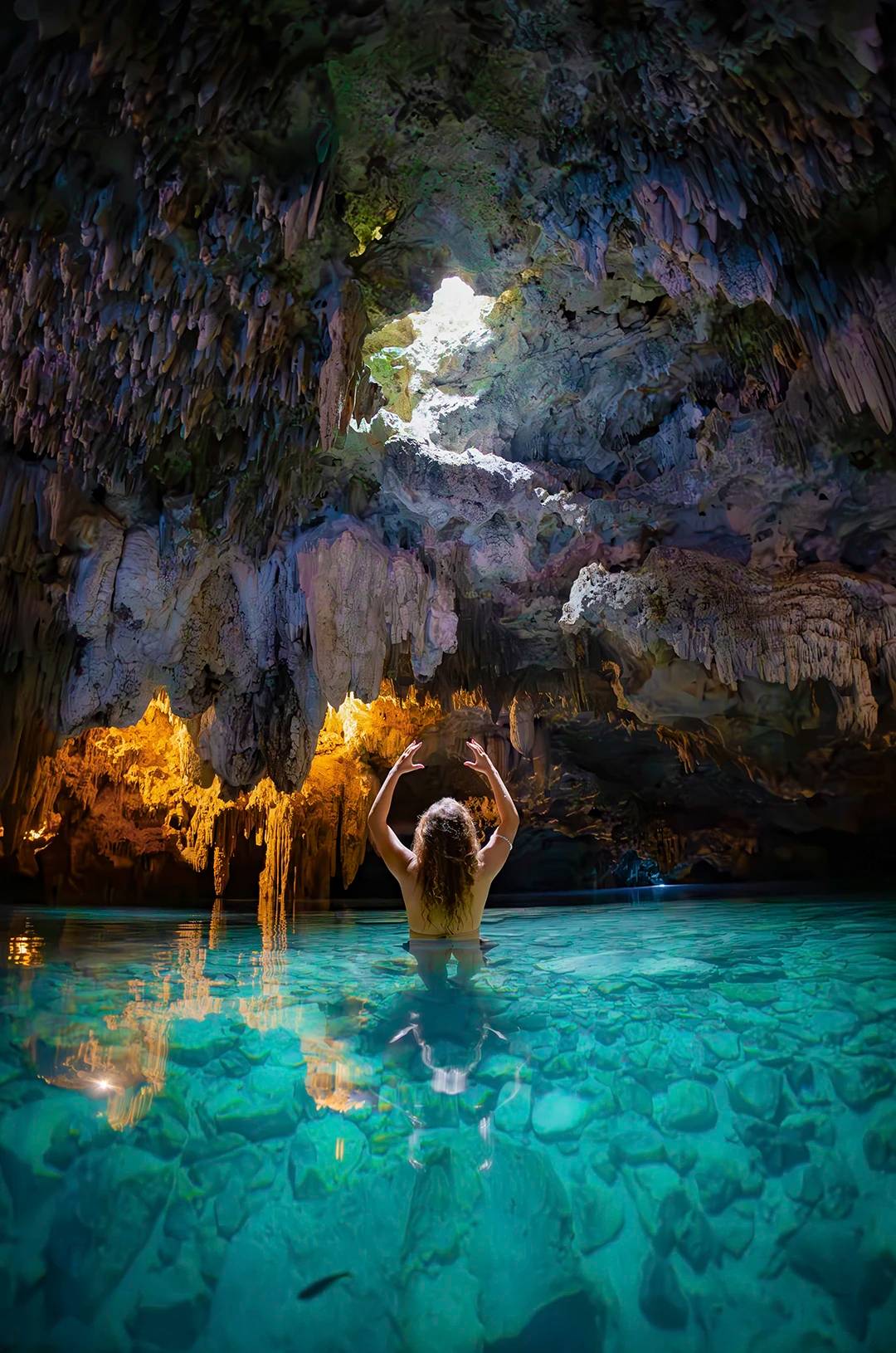 Girl exploring a cavern cenote in Cancun.