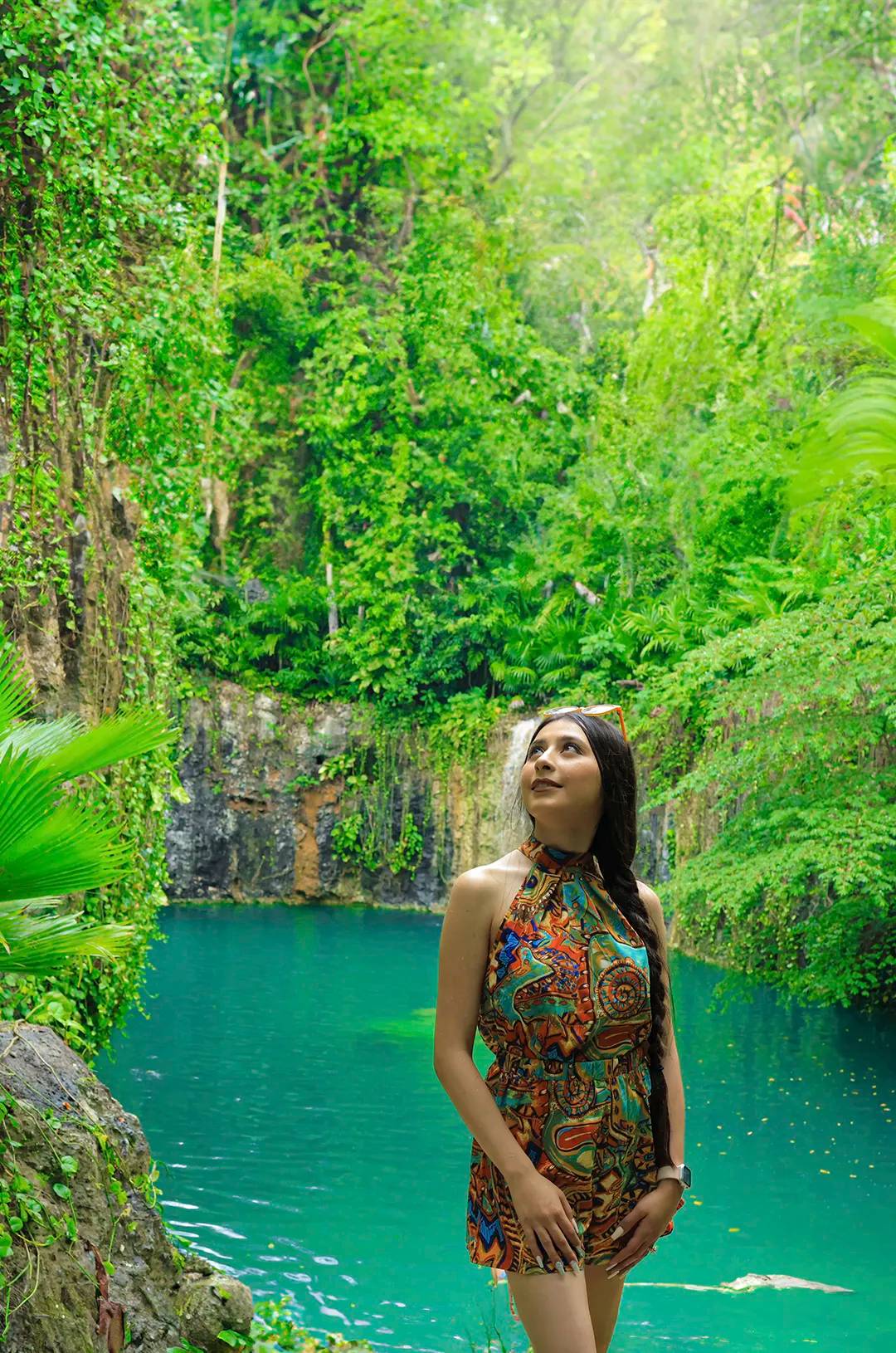 Woman posing at a cenote in Tulum, an ideal spot for a nature photoshoot.