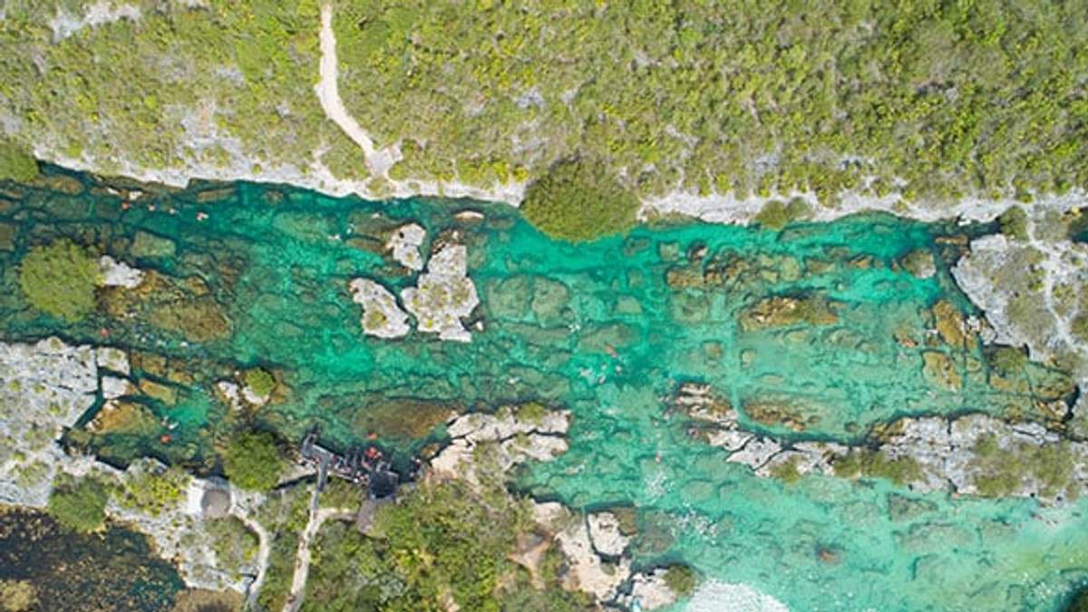 Vista aérea de las aguas turquesas y formaciones rocosas de la Laguna Yal Kú en Akumal.