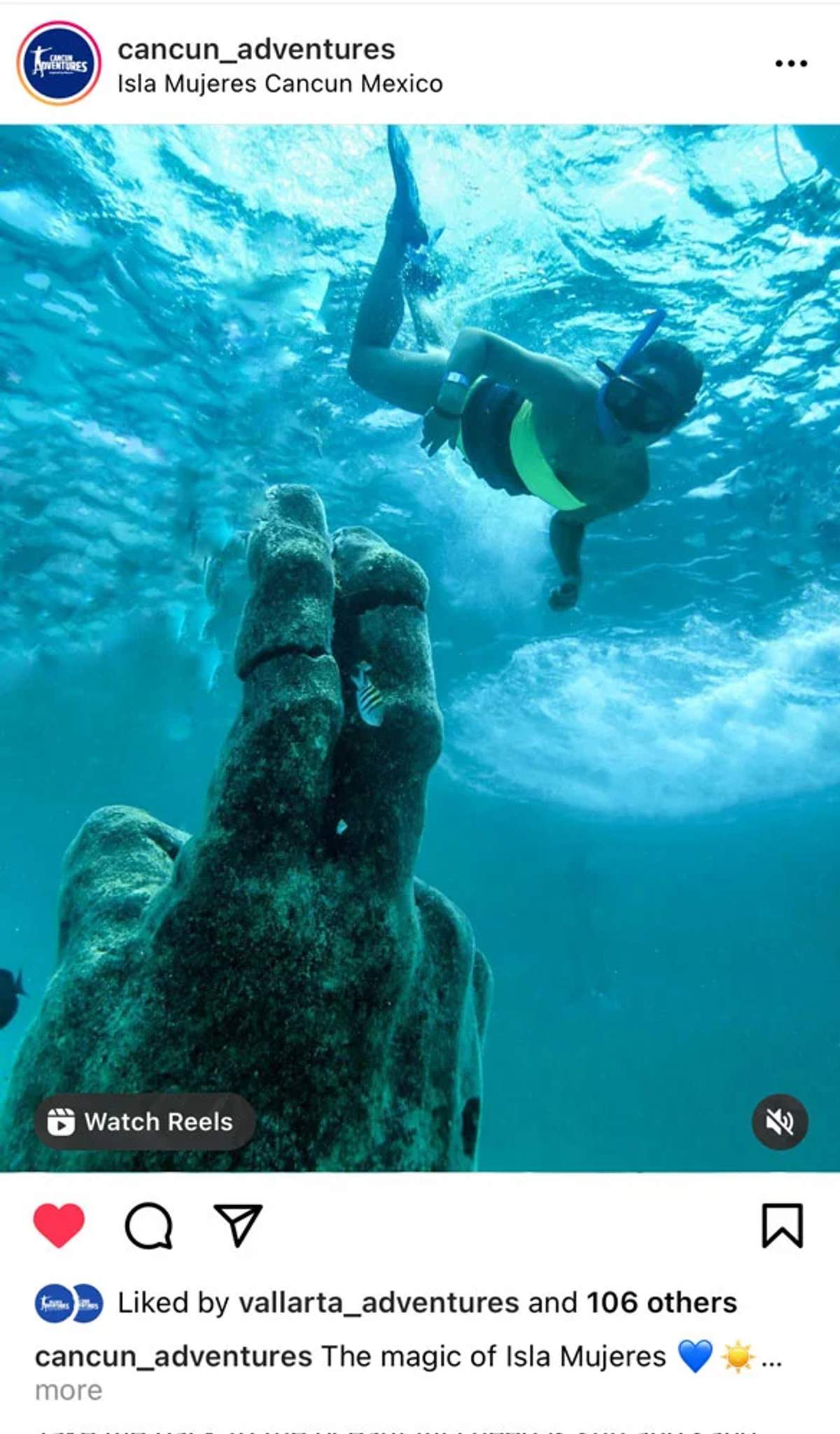 English Alt Text: A snorkeler swims near an underwater statue of a hand in the clear waters of Isla Mujeres, Cancun, Mexico.