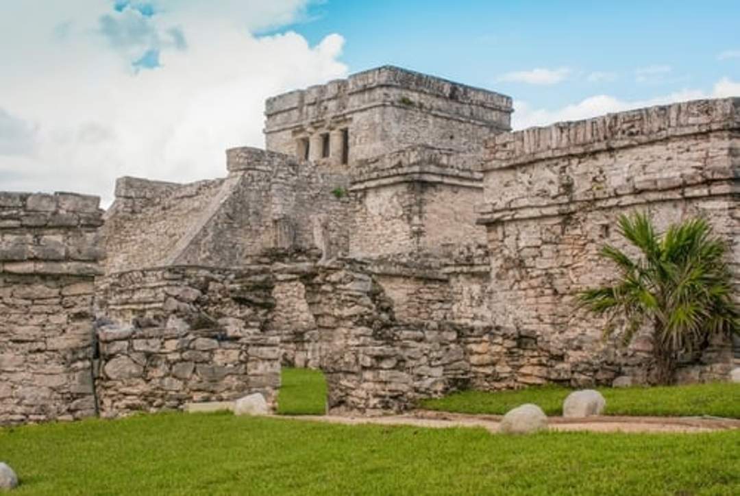 Tulum ruins in Mexico, showcasing ancient Mayan architecture against a clear sky.
