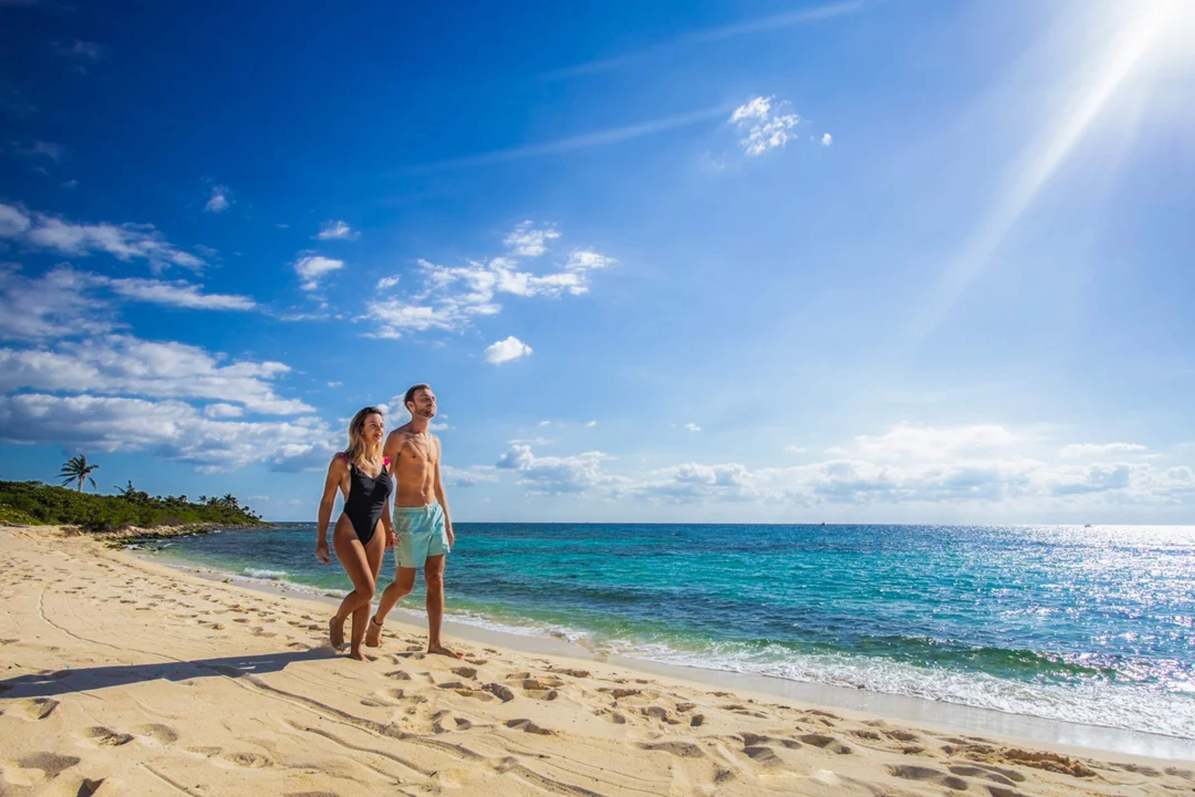 Woman in Cancun wearing a white hat and red skirt, perfect for a beach day.