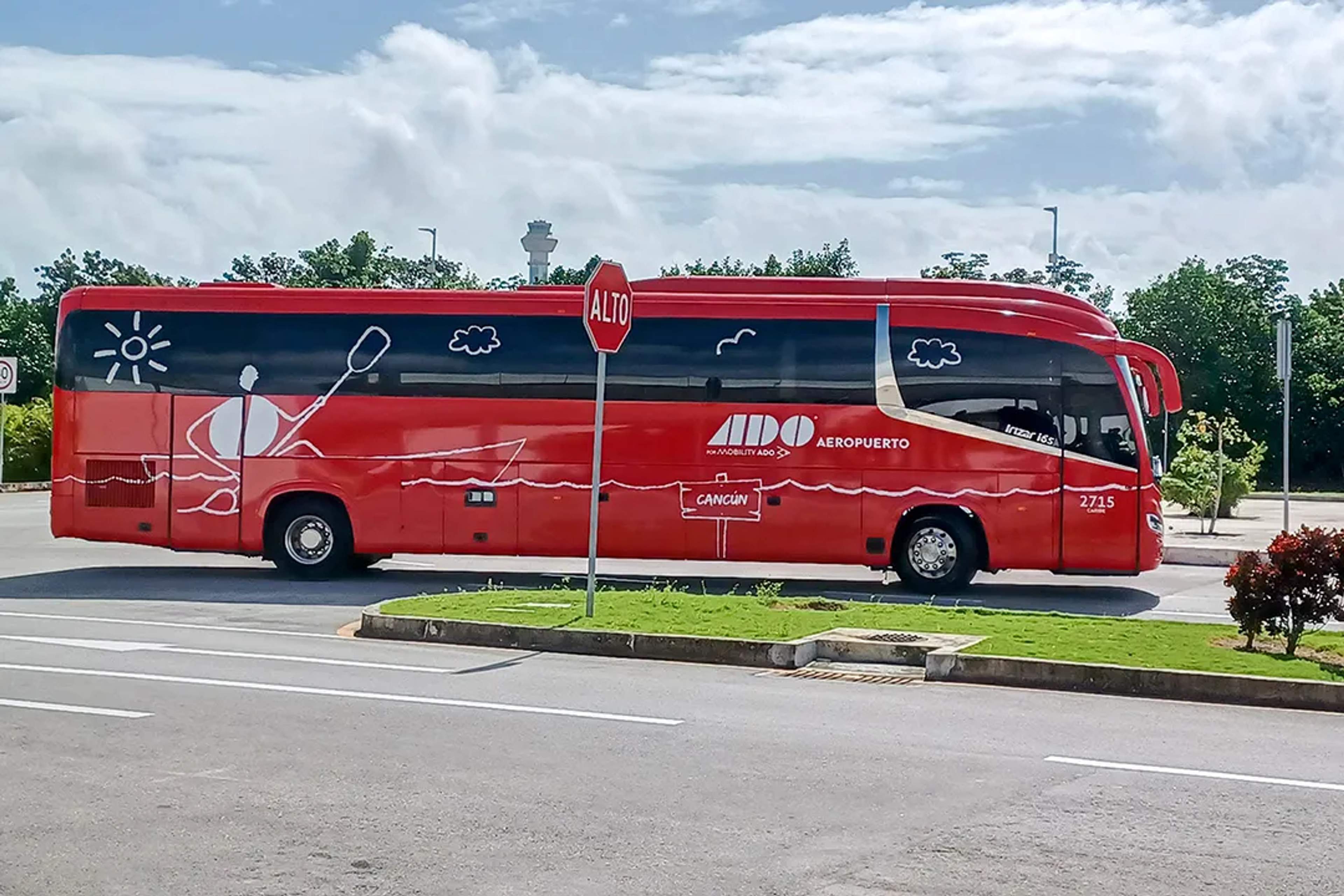 Red ADO Aeropuerto bus transporting travelers in Cancun, connecting the airport with downtown and hotel zones