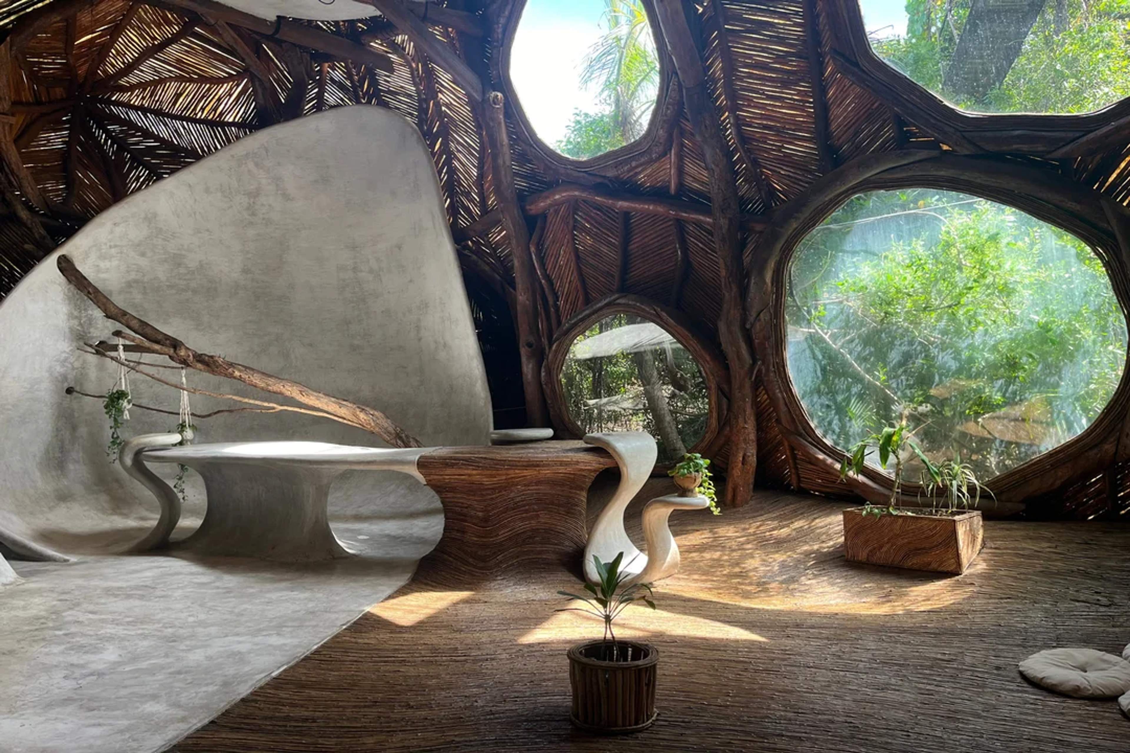 Organic architecture meets jungle views in this artistic space filled with curves, light, and nature.