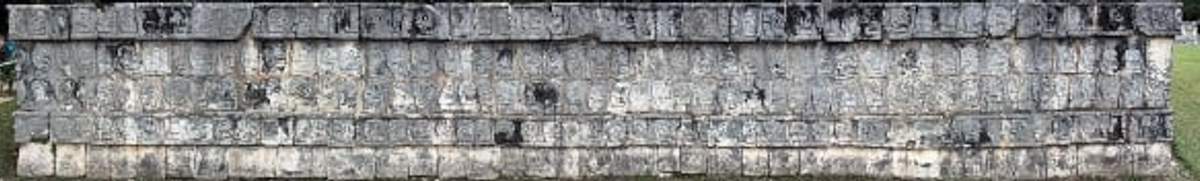 Wall of carved skulls at the Tzompantli platform in Chichen Itza, used for displaying the skulls of sacrificial victims.