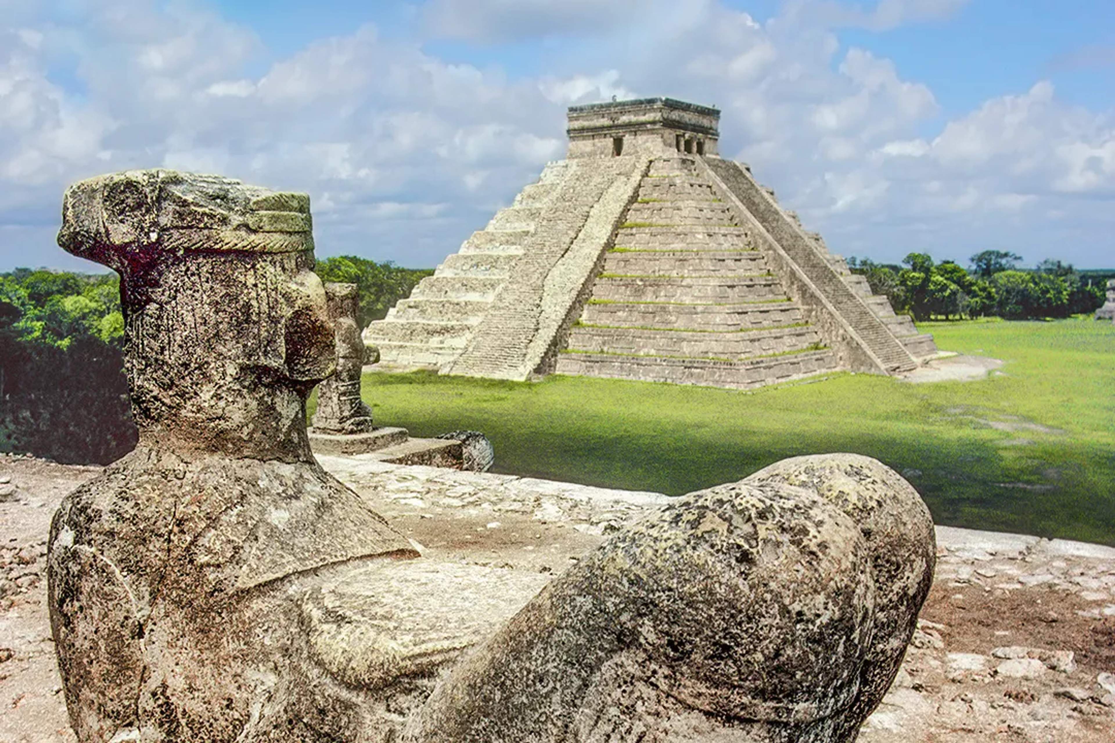 Chichen Itza pyramid with a Chac Mool statue, highlighting Cancun's historical significance in Mexico.