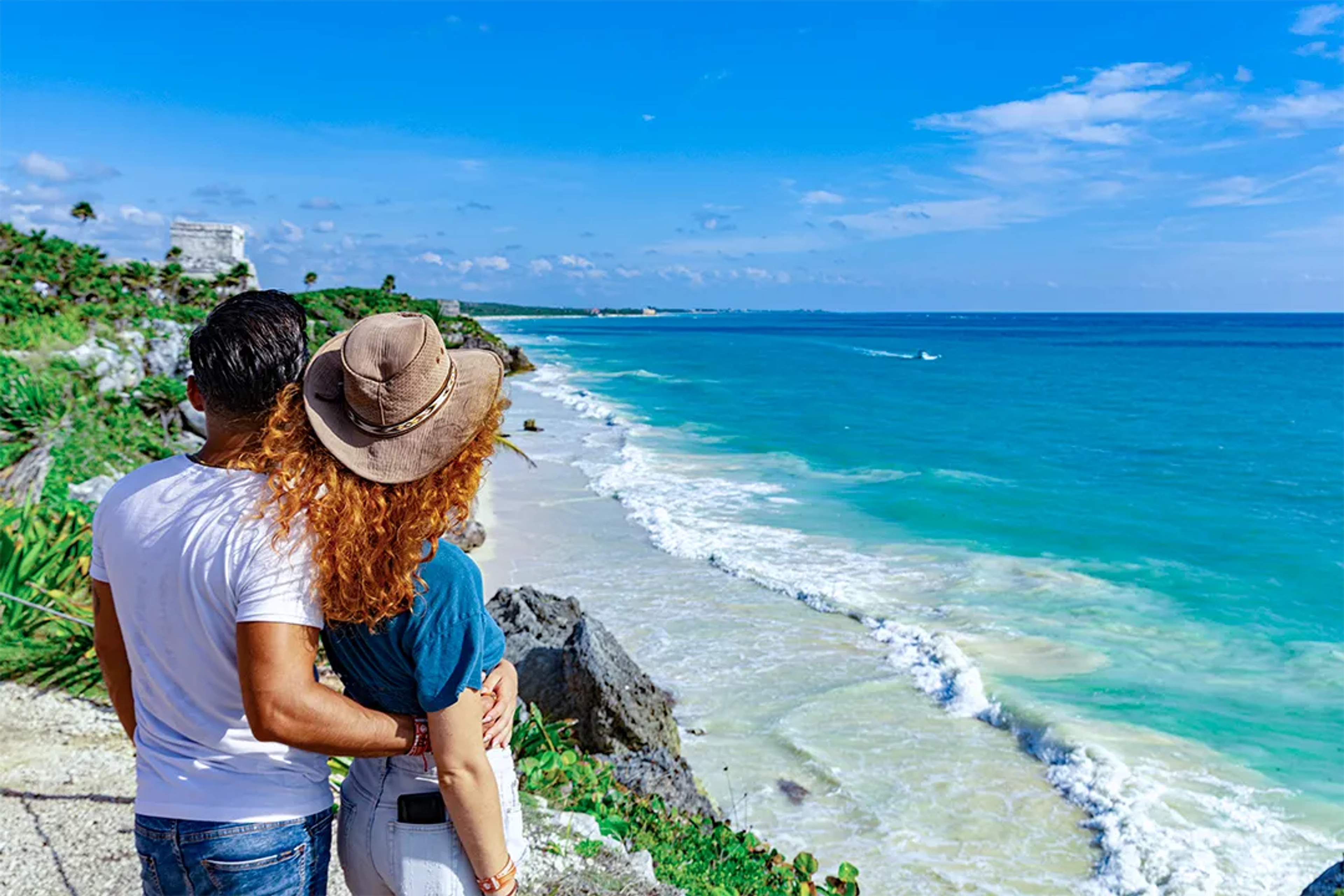 Romantic couple enjoying a scenic beach view in Cancun.
