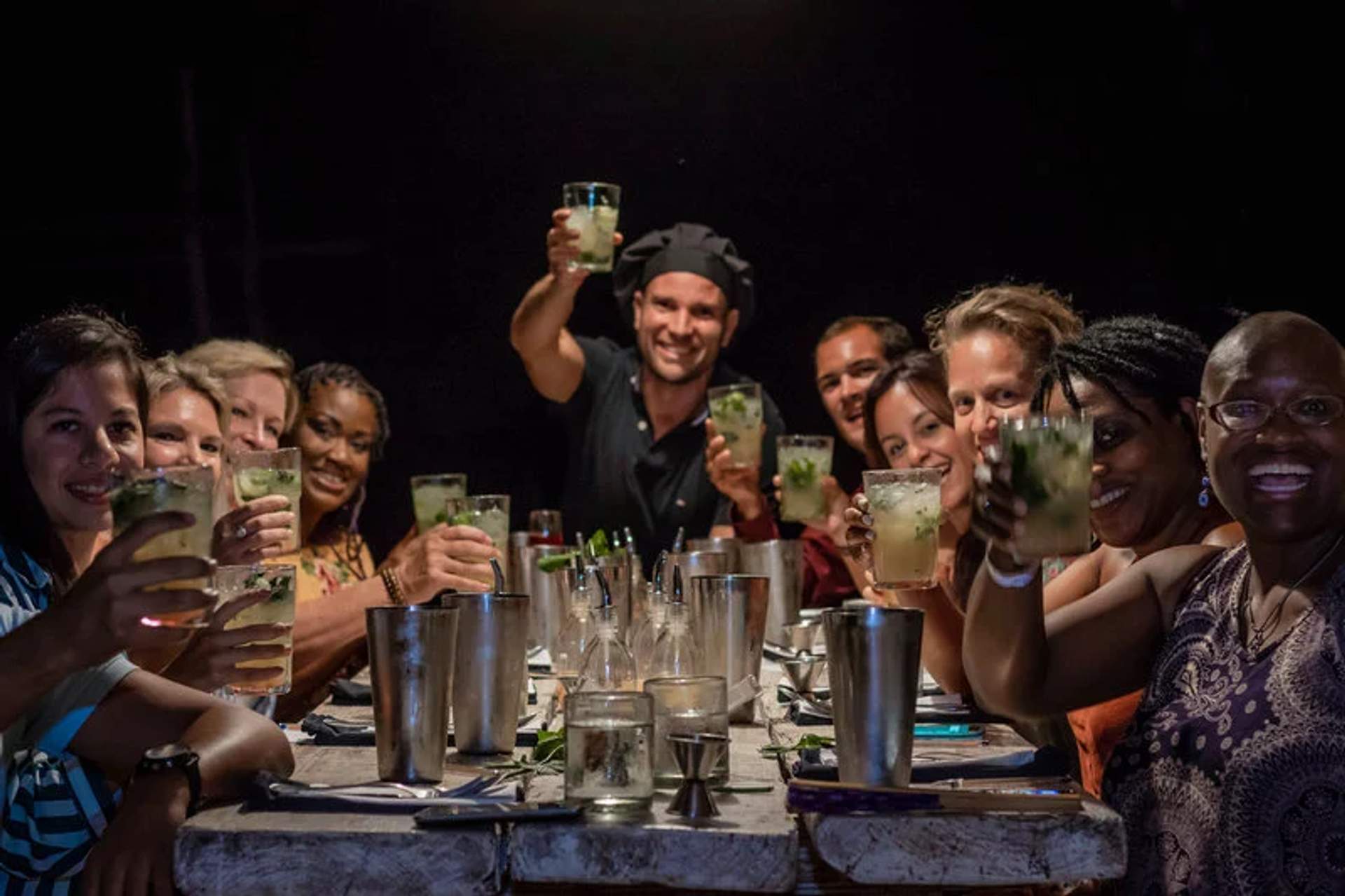 Guests enjoying cocktails at Traveler's Table tour by Cancun Adventures, sharing a unique dining experience.