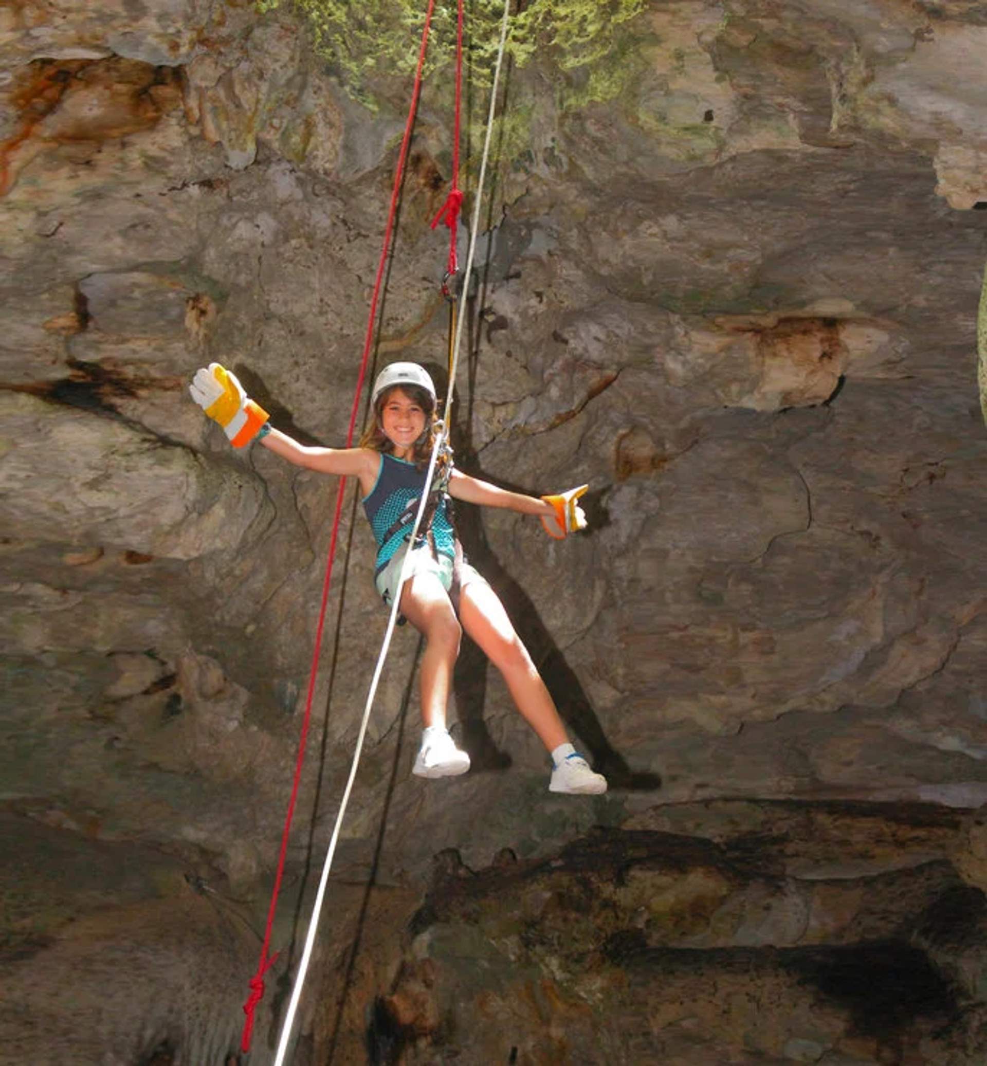 Child enjoying a zipline adventure, ideal for kid-friendly tours in Cancun.