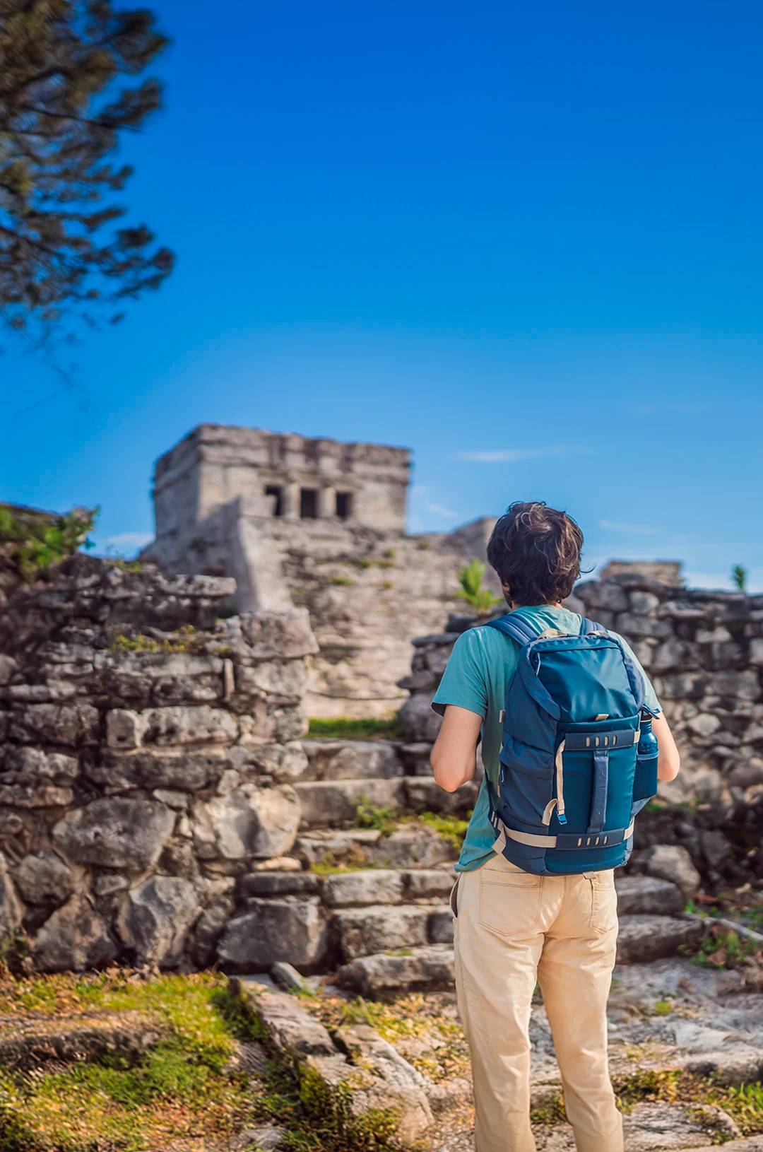 Traveler admiring Tulum archaeological site.