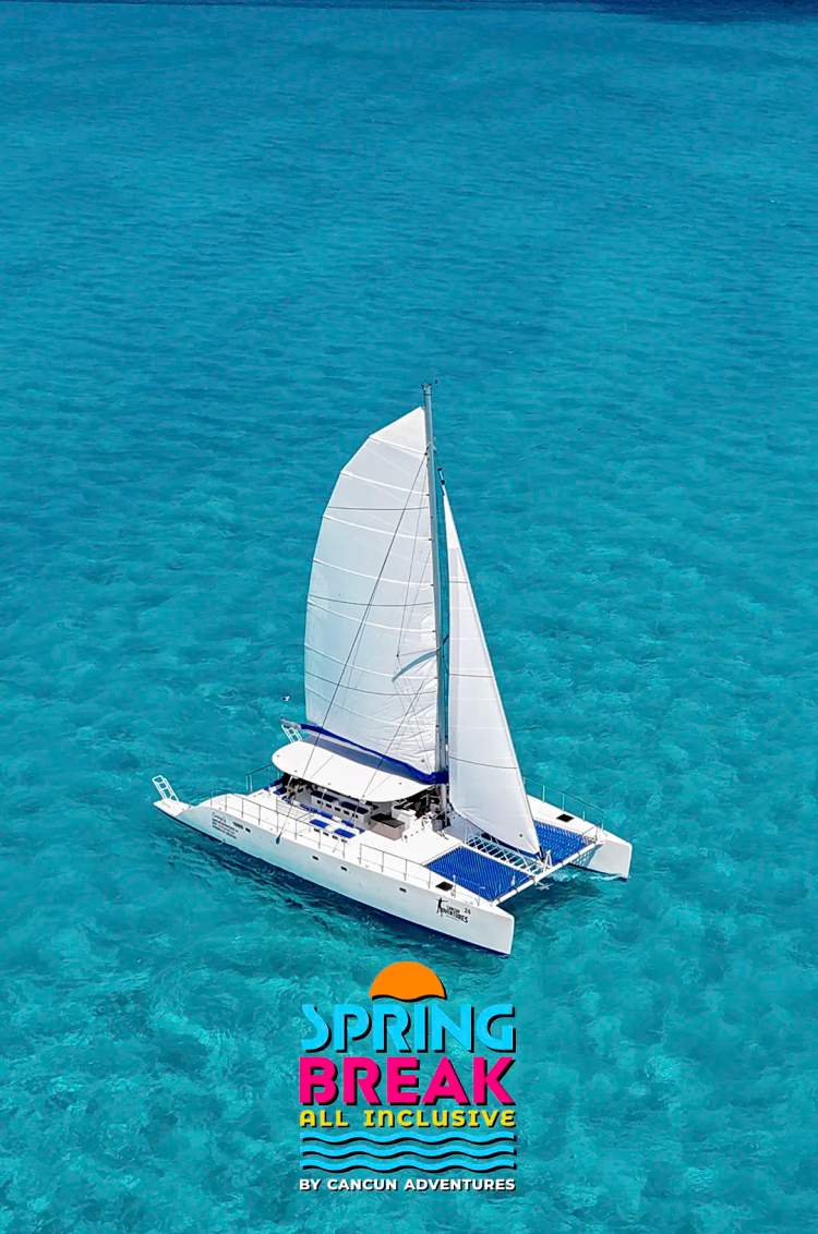  A white catamaran sails through crystal-clear turquoise waters, promoting Cancun Adventures' Spring Break tour.