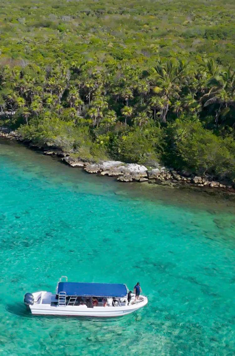 Aerial view of the Akumal cove with a Cancun Adventures tender boat.