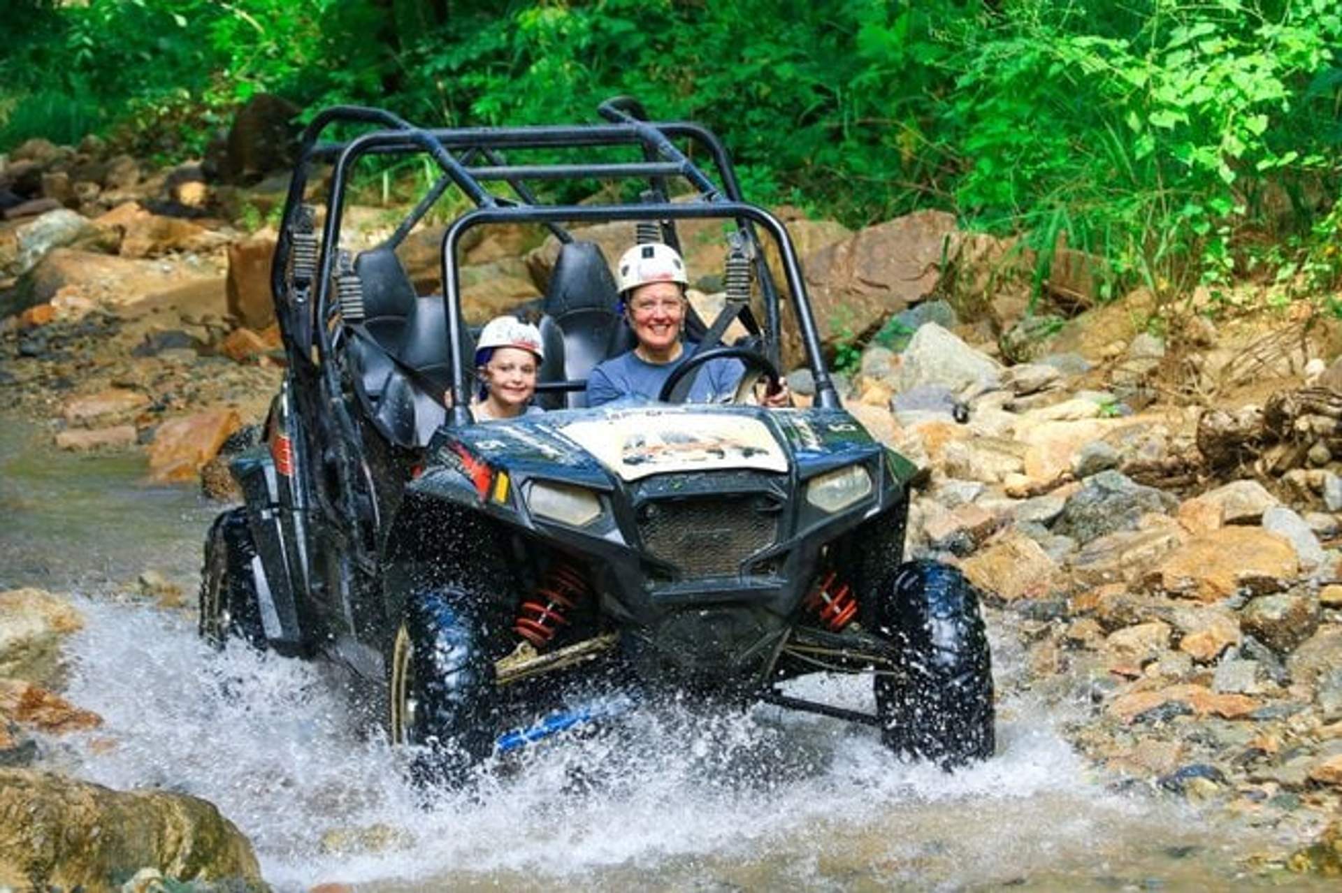 Father and child enjoying an ATV tour, perfect for kid-friendly adventures in Cancun.
