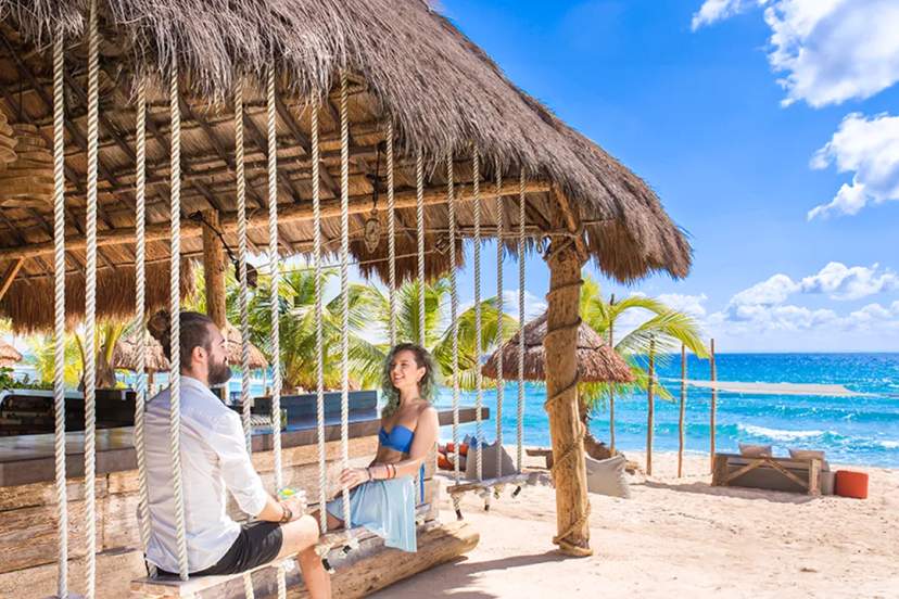 Pareja en el club de playa Punta Venado en Playa del Carmen, disfrutando del día.