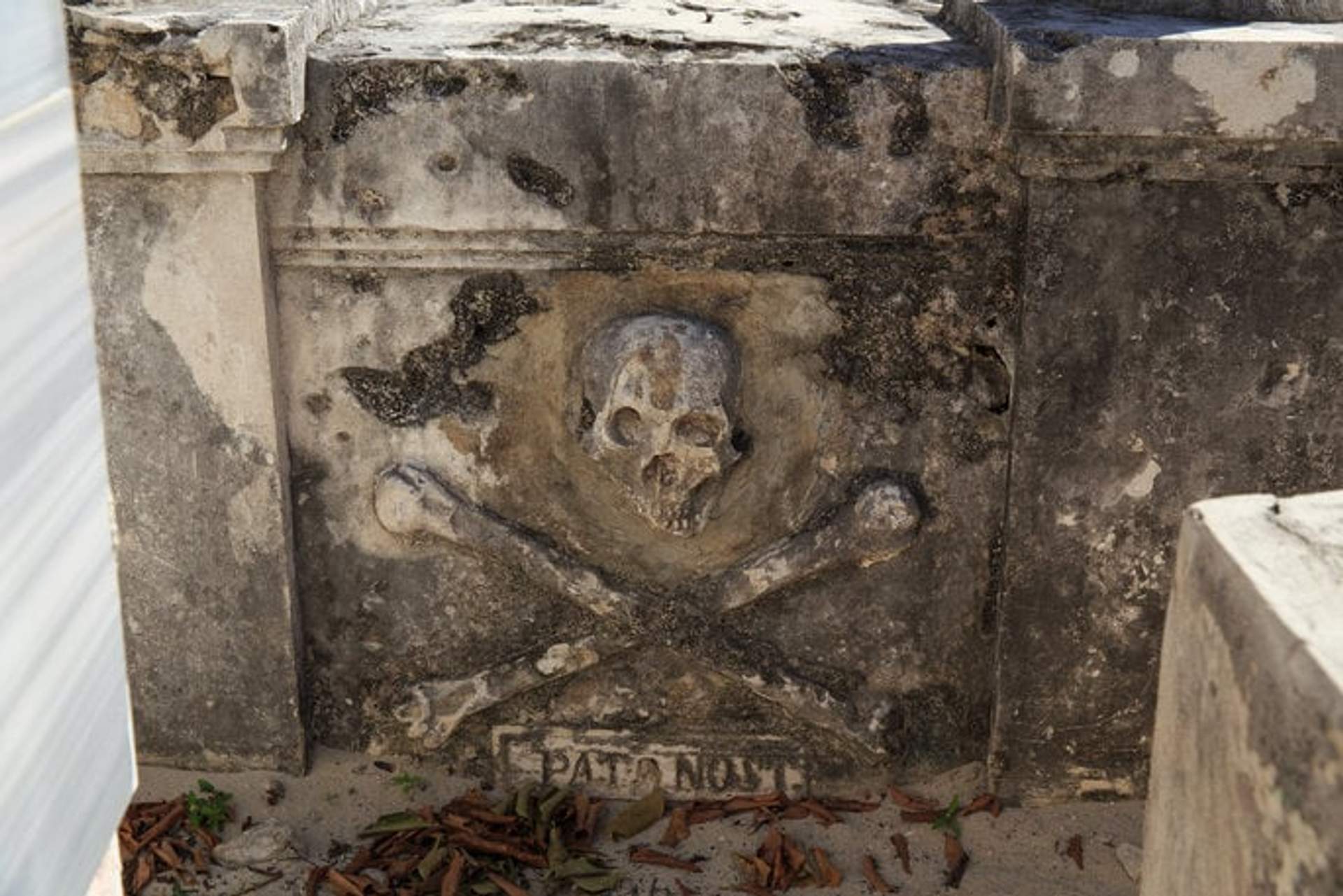 Grave of the pirate Mundaca on Isla Mujeres, featuring a skull and crossbones, symbolizing his pirate legacy and tragic love story.