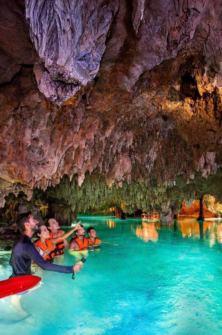 Travelers in a cenote cave guided tour in Cancun.