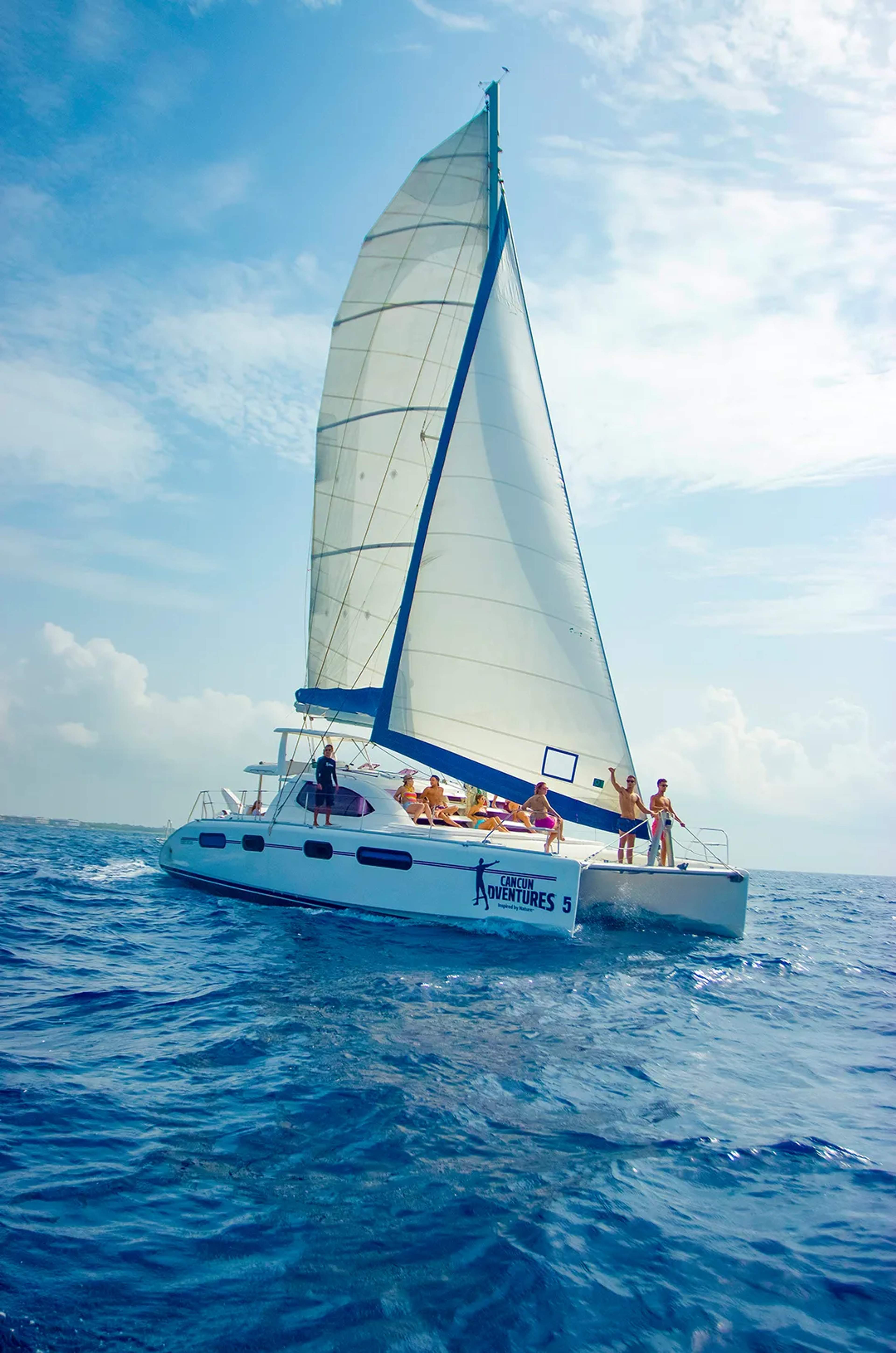 Catamaran sailing in the Caribbean Sea with Cancun Adventures, offering a relaxing ocean cruise and unforgettable views.