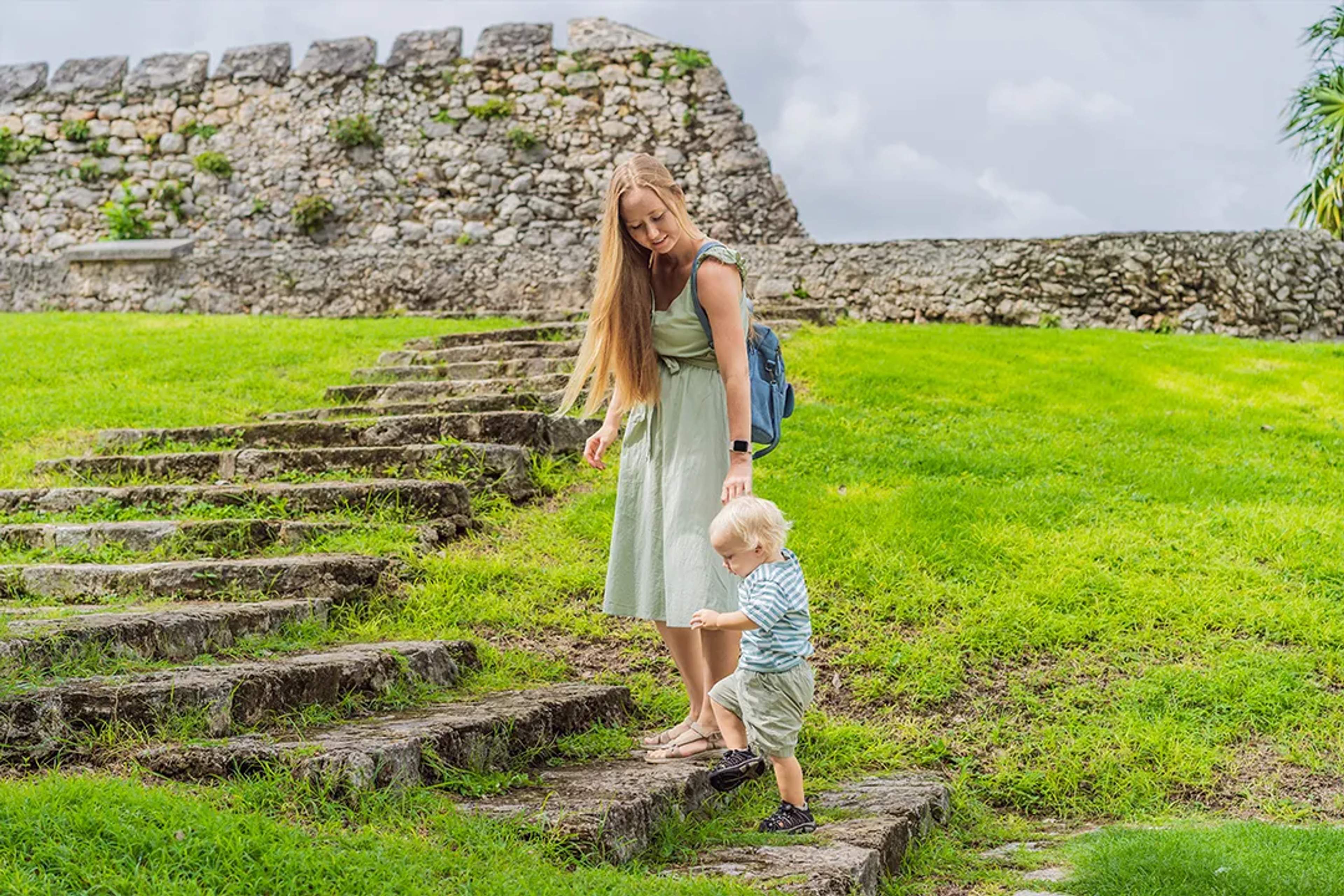 Mother and toddler exploring Mayan ruins in Cancun during a family-friendly cultural adventure tour