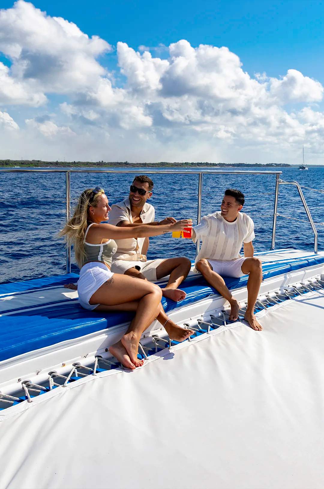 Group of friends toasting drinks on a boat under a sunny sky