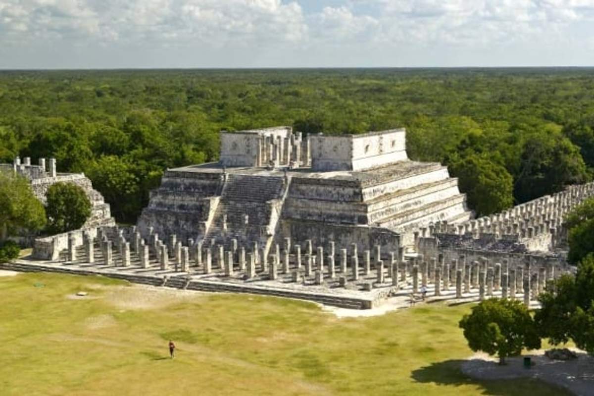Temple of the Warriors at Chichen Itza, a large stepped pyramid surrounded by rows of carved columns depicting warriors.