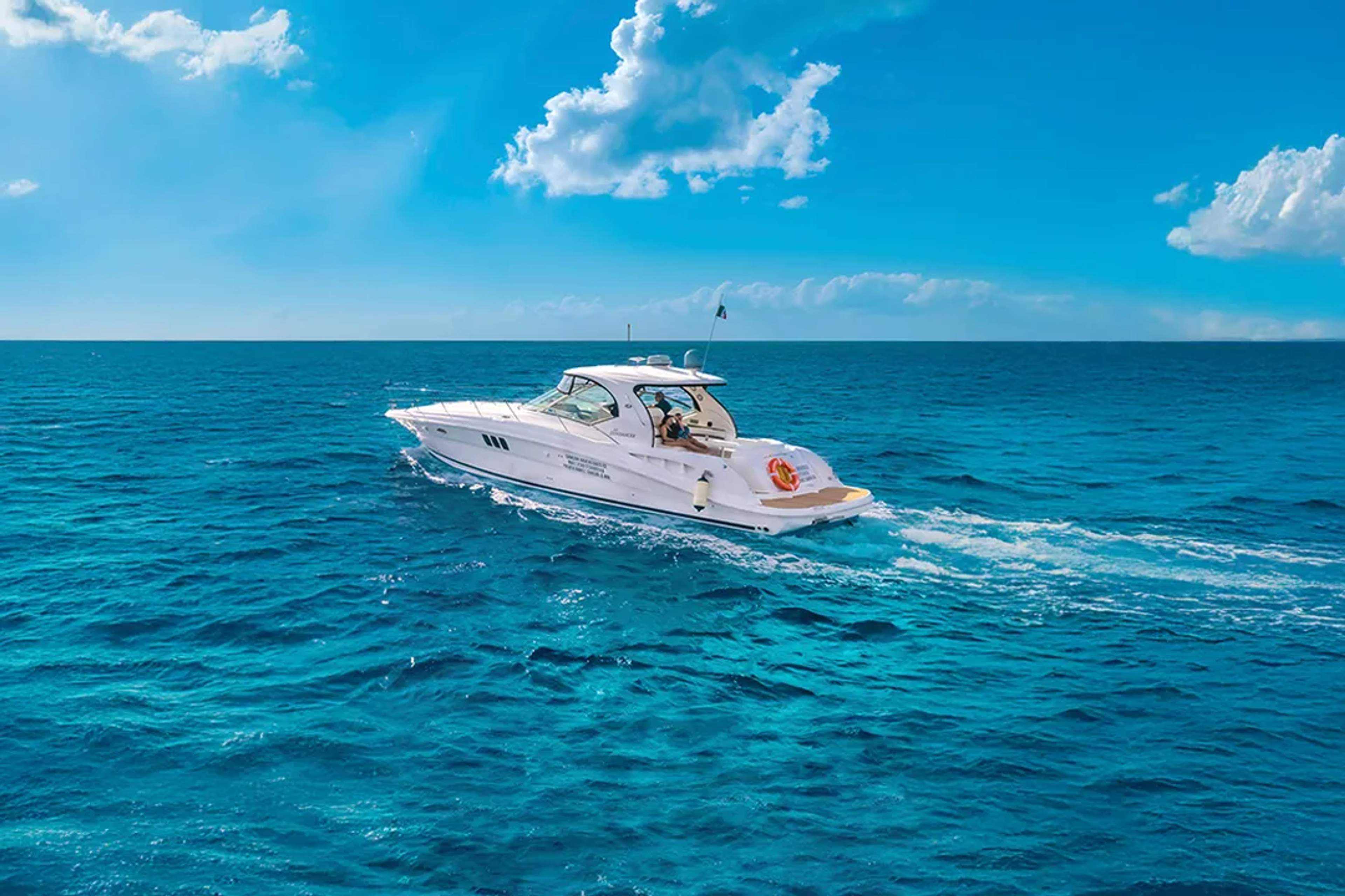 Private yacht cruising turquoise Caribbean waters, luxury boat tour with ocean views and relaxing onboard experience