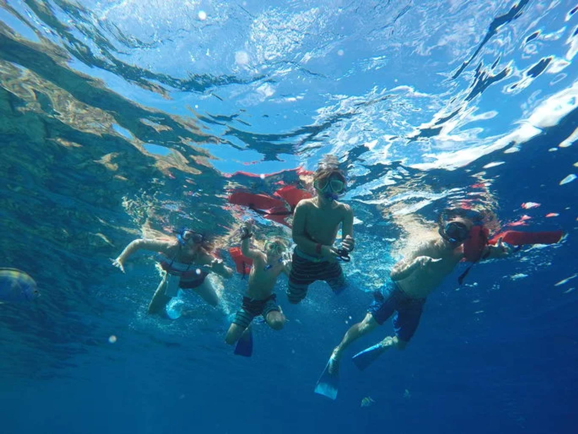 Kids snorkeling in clear waters, ideal for child-friendly water activities in Cancun.