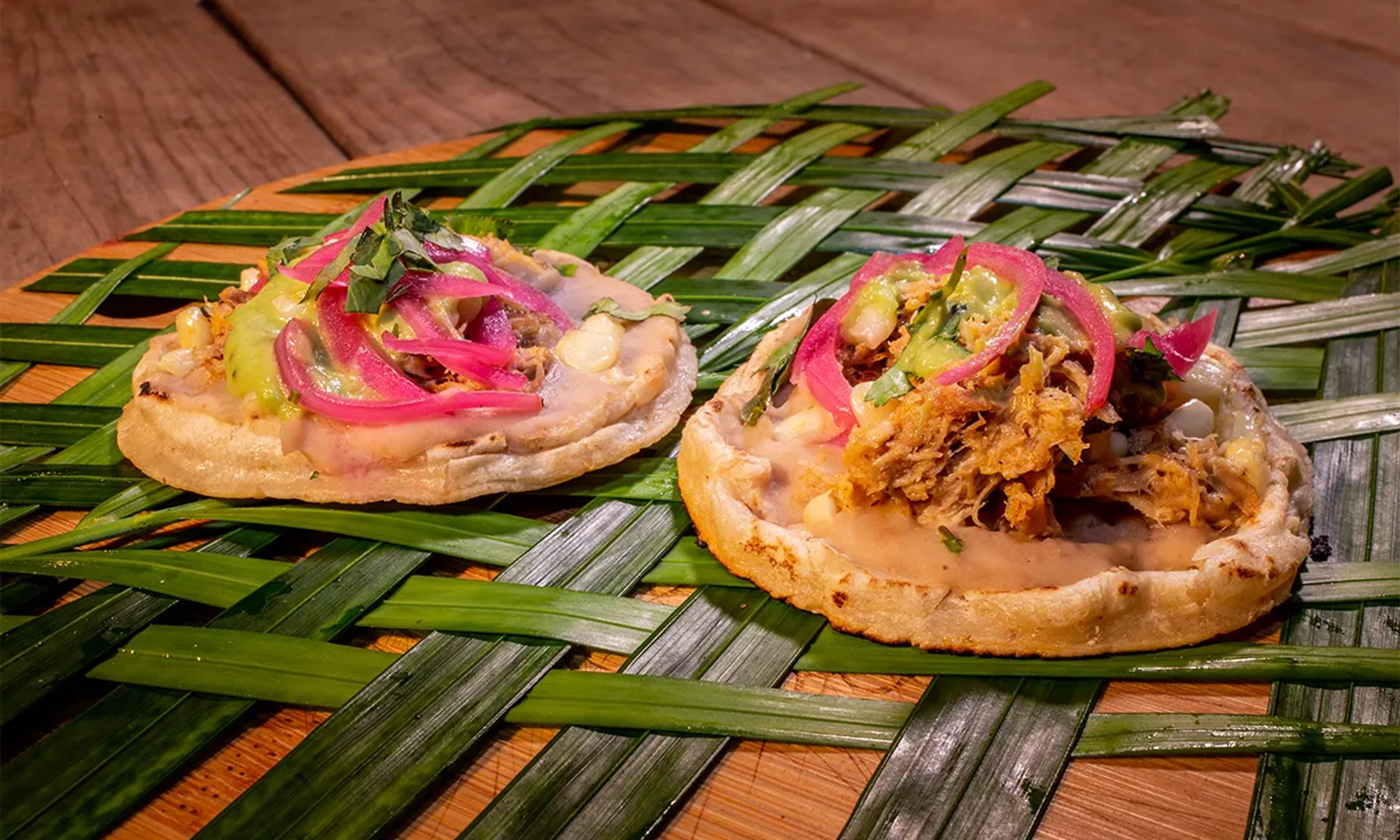 Delicious sopes with cochinita pibil and pickled red onions, a classic of Yucatecan cuisine in Cancun.