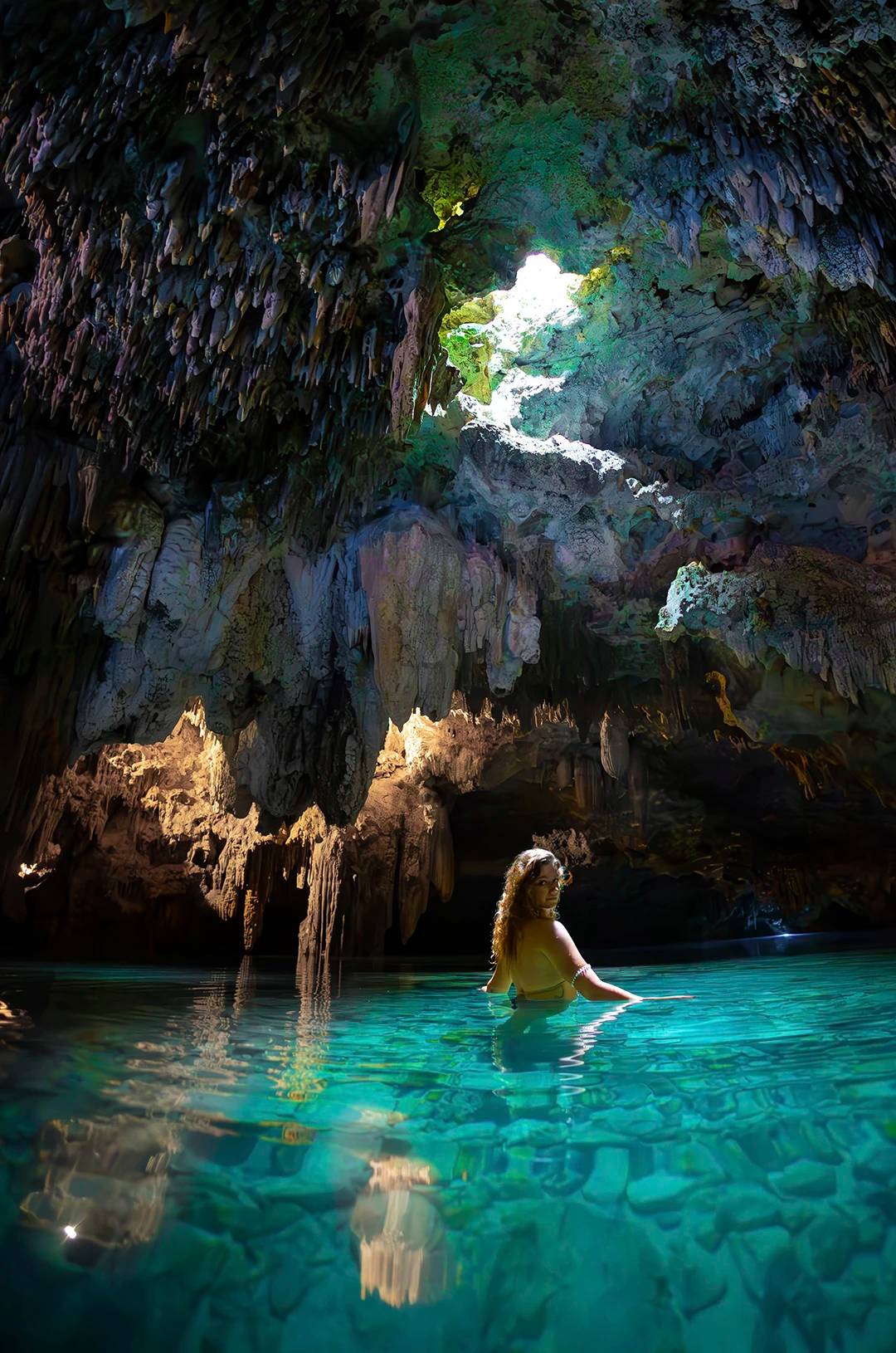 Traveler admiring an cenote cave.