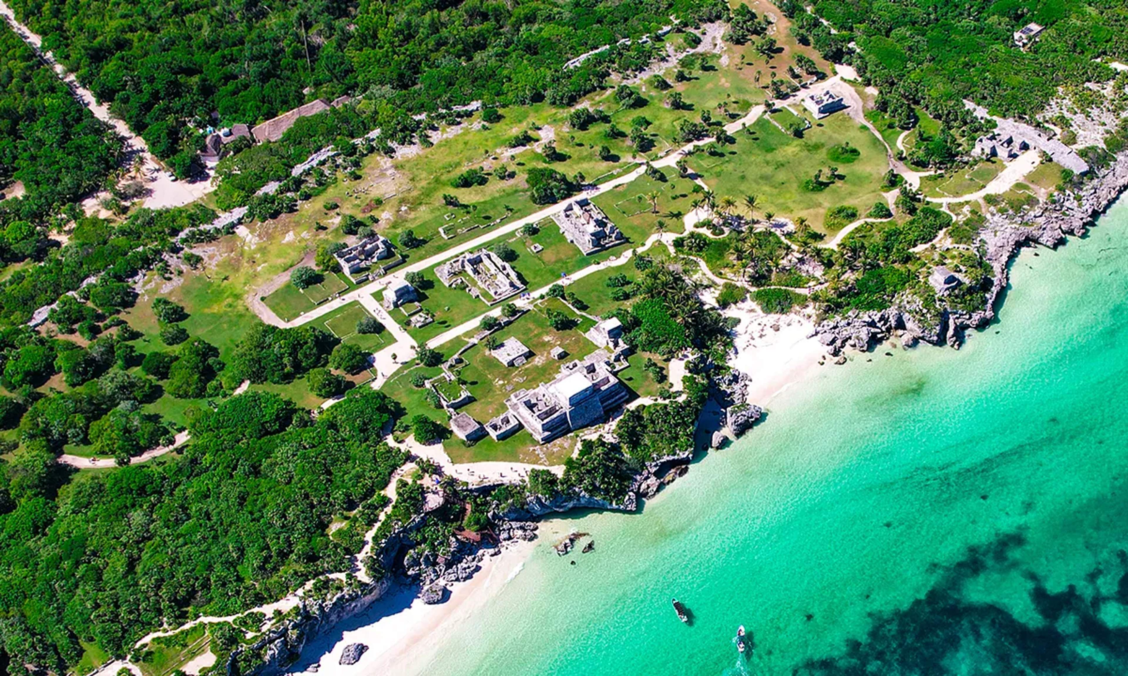 Aerial view of the Tulum ruins by the Caribbean Sea, blending Mayan history with crystal-clear waters.