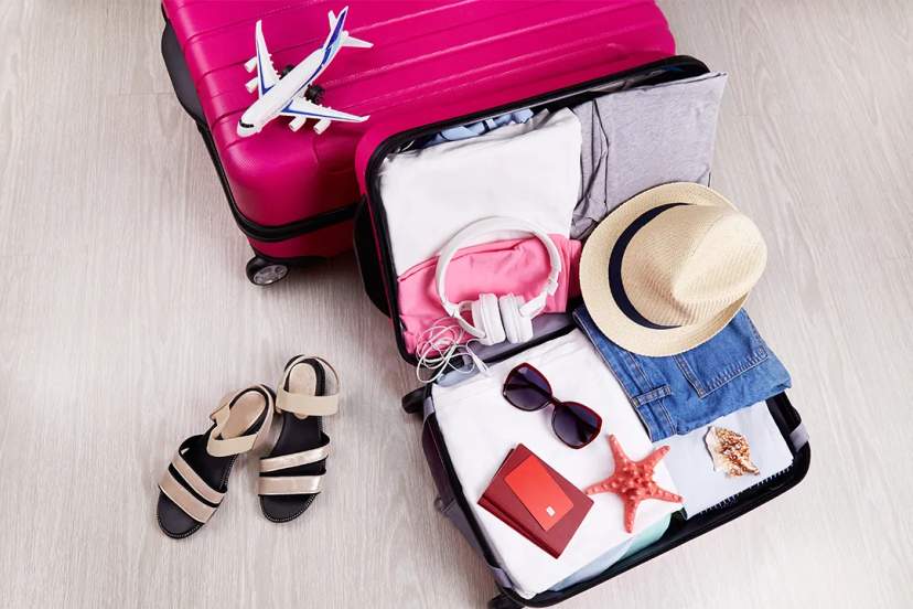 Packed suitcase with travel essentials for a Chichen Itza tour from Cancun and Riviera Maya adventure