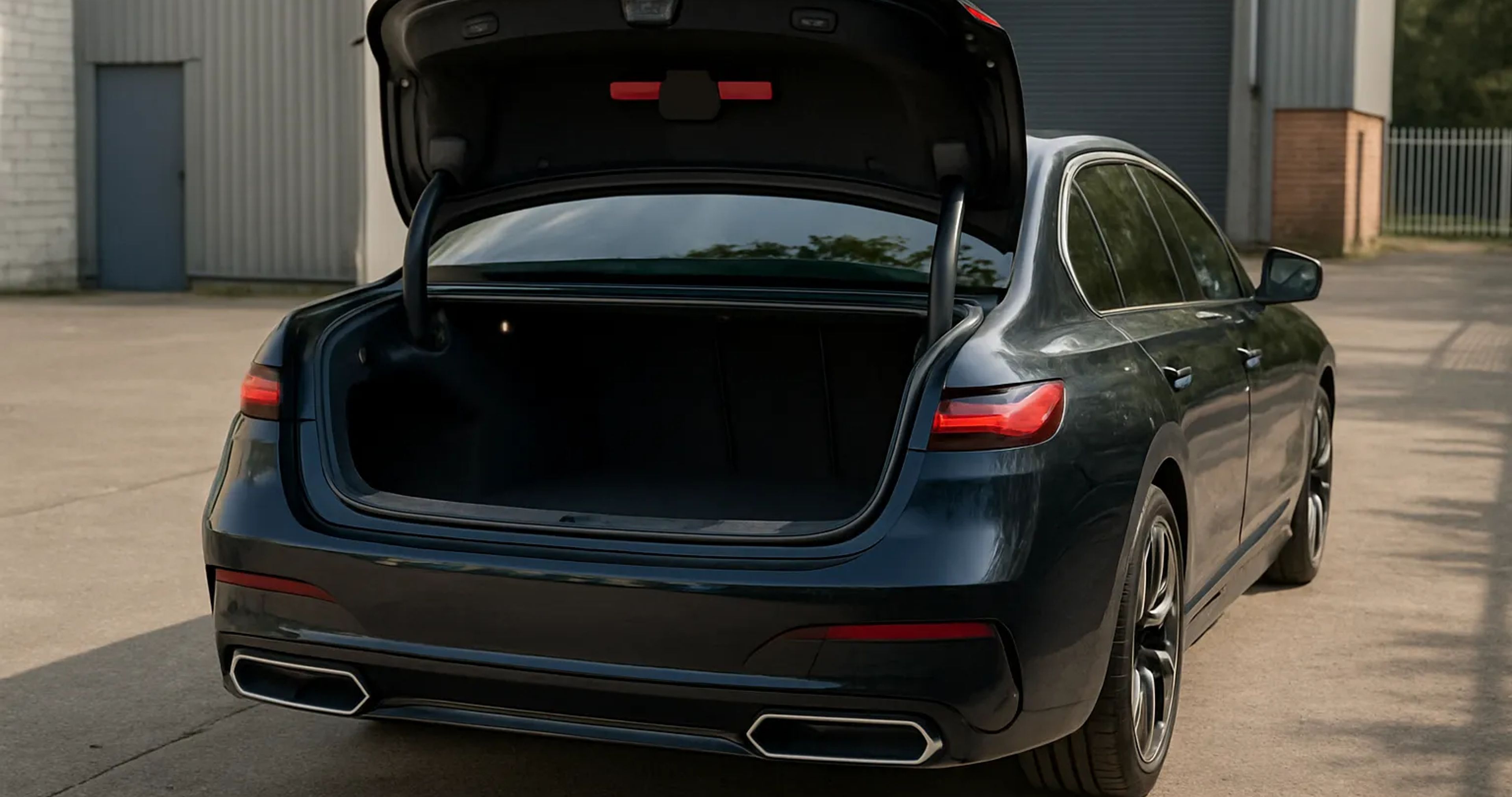 Back of a BMW i7 with it's trunk open