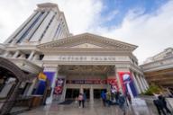 People walk toward the entrance of Caesars Palace in Las Vegas, decorated with Super Bowl LVIII banners.
