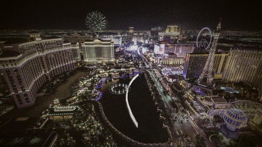Nighttime aerial view of the Las Vegas Strip with illuminated resorts, the Bellagio fountains,
