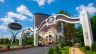 The entrance archway and sign of the Encore Boston Harbor resort with its bronze hotel tower in the background.