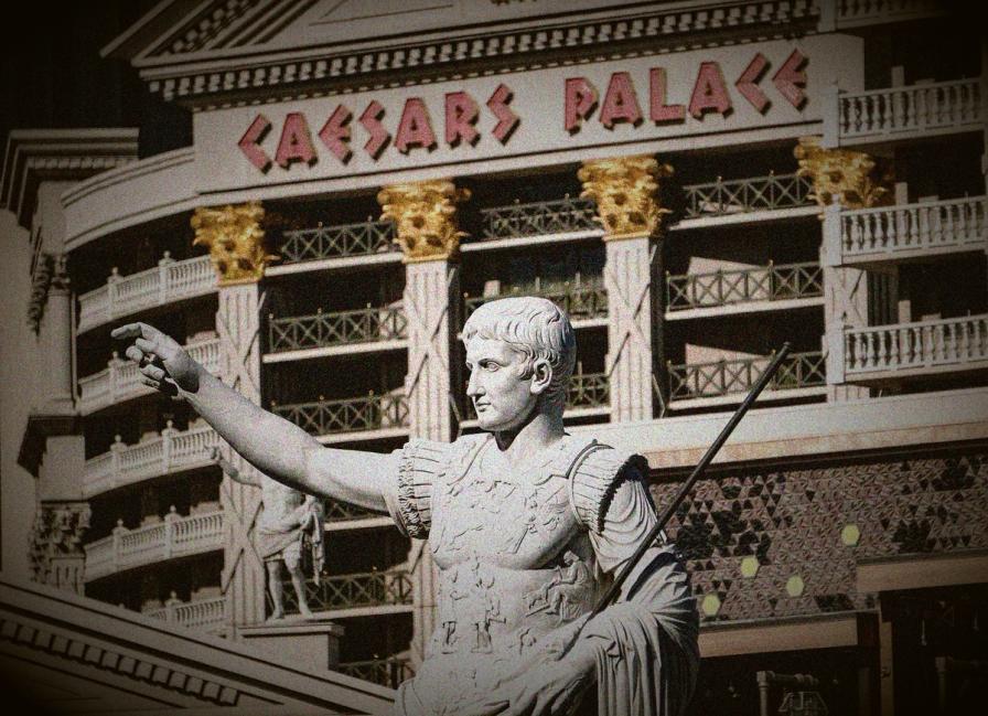 Statue of Augustus Caesar pointing forward in front of the Caesars Palace hotel facade in Las Vegas.