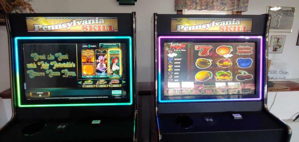 s go with: "Two Pennsylvania Skill electronic gaming machines side-by-side, displaying colorful slot-