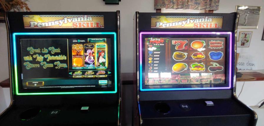 s go with: "Two Pennsylvania Skill electronic gaming machines side-by-side, displaying colorful slot-