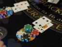 Playing cards and stacks of poker chips on a blackjack table.