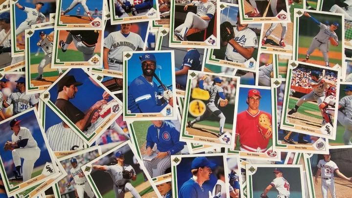 A scattered, overlapping pile of vintage baseball cards from the late 1980s and early 1990s.