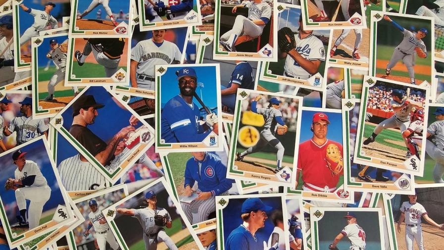 A scattered, overlapping pile of vintage baseball cards from the late 1980s and early 1990s.
