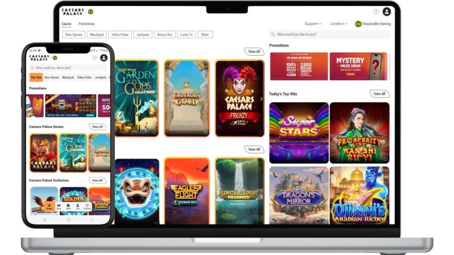 A laptop and smartphone displaying the Caesars Palace online casino interface with various slot and table games.