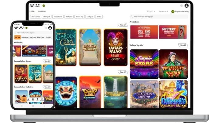 A laptop and smartphone displaying the Caesars Palace online casino interface with various slot and table games.