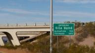 Green road sign reading Entering Gila Bend, Elevation 735, Founded