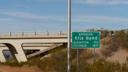 Green road sign reading Entering Gila Bend, Elevation 735, Founded