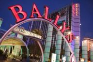 A large red neon Bally's sign arches over a walkway with the Bally