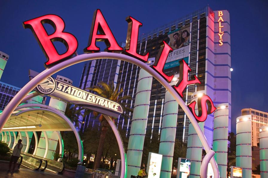 A large red neon Bally's sign arches over a walkway with the Bally